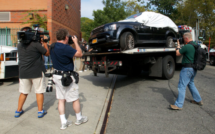 Photographers, videographers and newspapers reporters take pictures of the sport utility vehicle involved in a road rage incident where motorcyclists attacked the driver after damaging his vehicle. Crime reporters face many challenges to access information, including long waits during stakeouts. Photo: Alejandro Dávila.