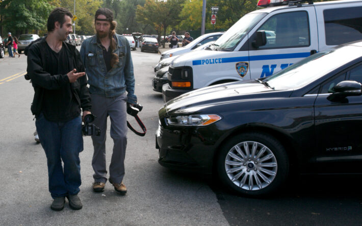 From left: Freelance crime reporters Boris Kaykov and David Greene walk to a nearby bodega after putting more than 10 hours in a stakeout outside the 33rd Police Precinct. 