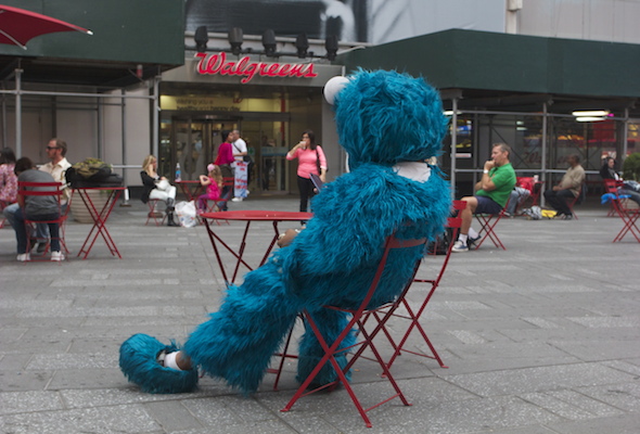 Lu Martinez, 22, takes a rest from panhandling in Times Square. 