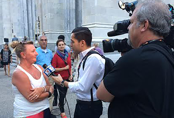 South Florida WPLG Local 10 News' Carlos Suarez interviews tourists outside of St. Patrick's Cathedral. Photo: Kathryn Thomson. 