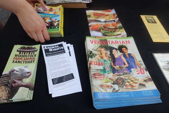 Members of FAUN hand out vegan educational flyers to passers-by 