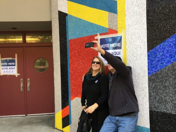 Gus Samios and Jacinta Orlando snap a selfie after casting their ballots at the Park West High School polling place at 525 West 50th Street.
