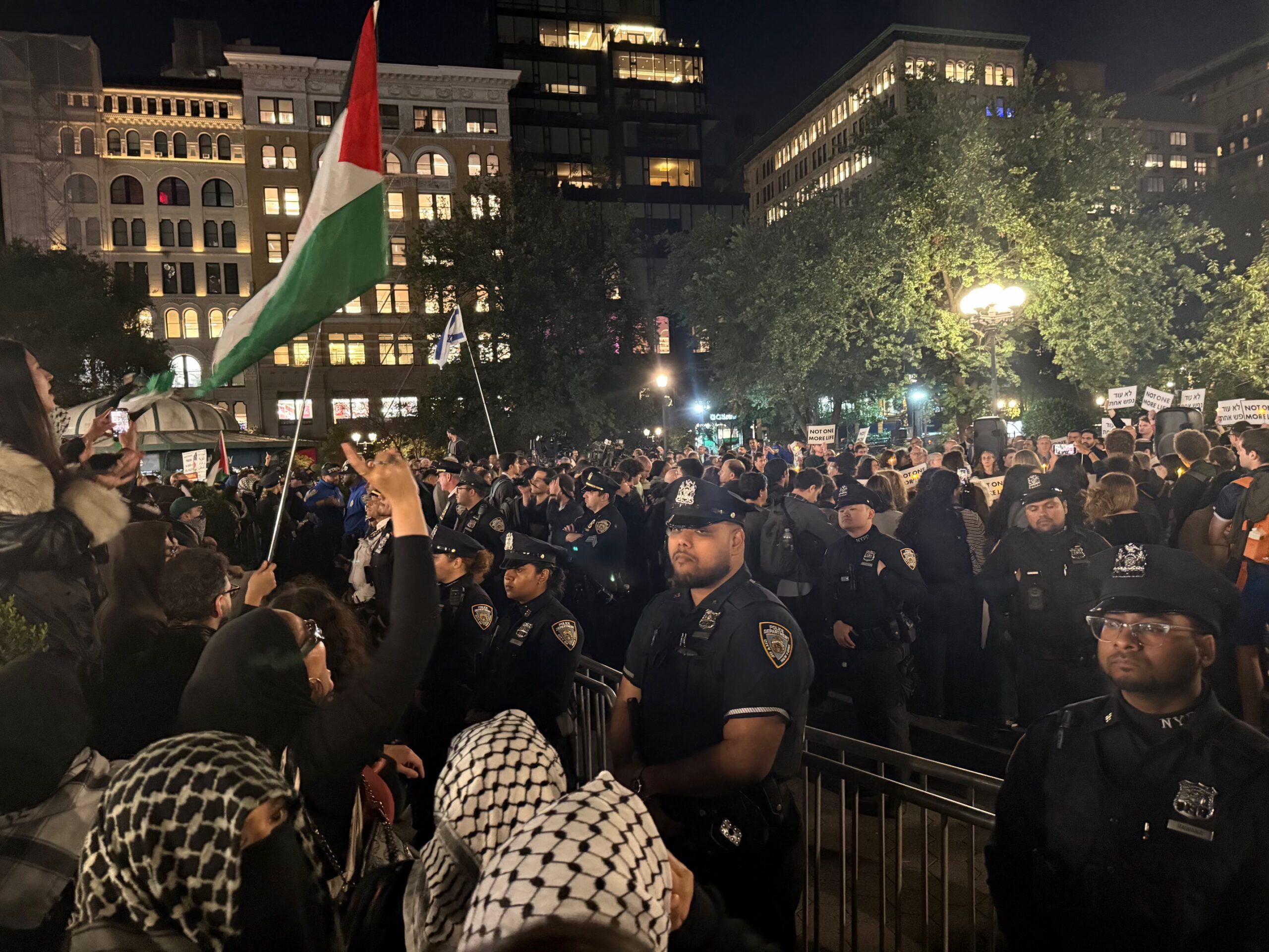 Vigil mourns Israelis and Palestinians as protesters chant nearby