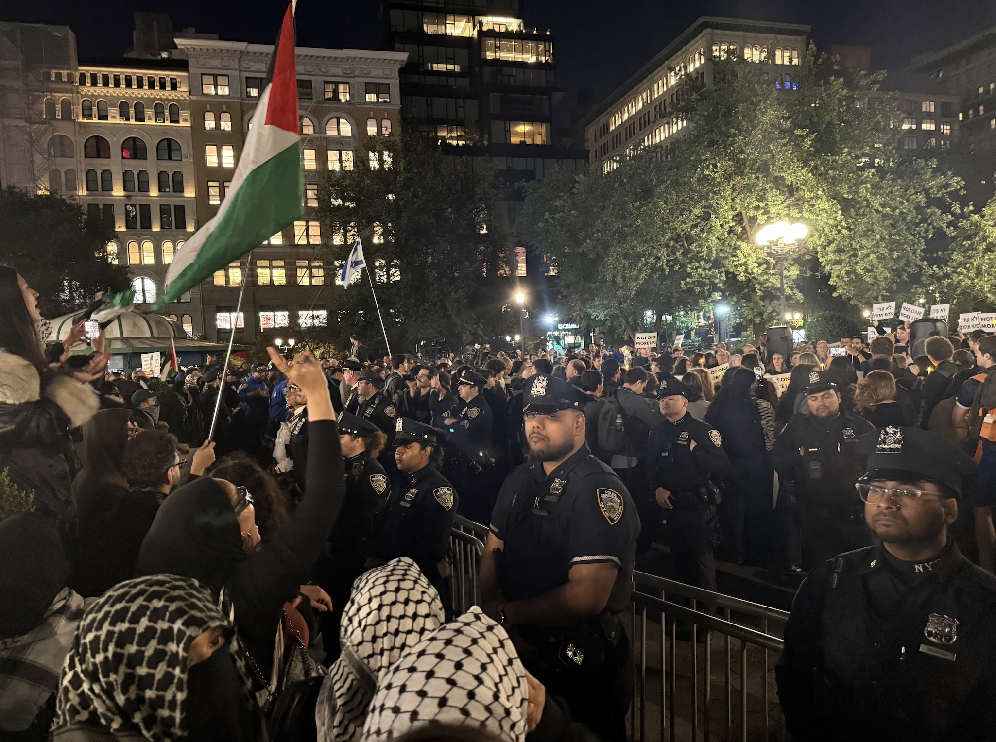Vigil mourns Israelis and Palestinians as protesters chant nearby